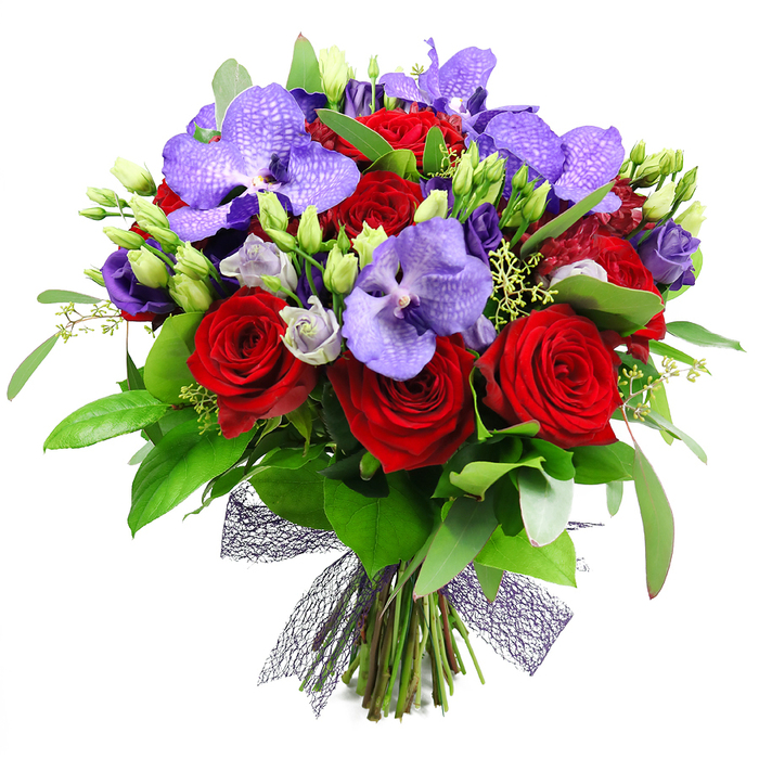 An opulent cascade of colour, this bouquet sweeps the eye with its combination of deep red and violet - an elegant harmony that feels both dramatic and refined. At its heart, fully bloomed red roses unfurl their velvety petals with classic romance, while purple Vanda orchids anchor the arrangement with exotic, broad petals tainted by speckles of lavender and indigo. Surrounding them are clusters of eustoma (lisianthus) in soft purple hues, some still in tight buds, others just opening to reveal lavender and almost silvery tones that lend a gentle glow. The verdant greenery-large, glossy leaves interspersed with slender stems-provides a lush frame that adds volume and a natural, garden-fresh texture. A handful of unopened green buds punctuate the design, and tiny pale-green filler sprigs weave through, adding delicate detail. The stems are neatly gathered and tied at the base with a decorative, near-black mesh ribbon, forming a contemporary, airy bow that completes the look with a touch of architectural elegance. This display radiates romance, celebration, and quiet luxury, making it ideal for anniversaries, Valentine's gifts, or a statement of deep admiration.
Delivered by Flowers New Barnet to New Barnet and nearby corners, the bouquet feels at once regal and accessible-perfect for milestones or intimate dinners. Picture it on a table near the area's leafy streets, perhaps close to Monken Hadley Common or along New Barnet High Street, where it would catch the glow of evening lights and invite conversation. The design's color narrative-ruby red, plum, and lilac-speaks of passion tempered by refinement, its scent a memorable blend of rose and orchid with the crispness of just-cut greenery. We arrange these stems with care for same-day delivery in the local area, ensuring the blooms arrive vibrant, with sturdy stems and a fragrance that lingers. In this bouquet, artistry and craft meet living emotion, a gift that speaks of devotion, celebration, and the generous spirit of our North London community.