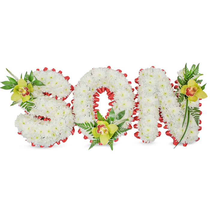 Elegantly presented against a plain white backdrop, this handcrafted floral tribute spells SON in three-dimensional letters made from dense groupings of small white chrysanthemums. The chrysanthemums are placed so closely together that each letter reads as a single, gentle mass of petals-a visual metaphor for purity and remembrance. A vibrant red ribbon traces the outline of each character, formed into a series of neat scallops that provide an artisan's touch and a vivid contrast to the white, like a quiet heartbeat along the edge. At thoughtful points of emphasis-upper left of the S, in the hollow of the O, and along the upper right of the N-sit lime-green Cymbidium orchids whose smooth, waxy petals show a soft yellow-green hue with distinctive reddish-brown markings in their throats.
Complementary green foliage and slender fern fronds cluster around each orchid, their varied leaf shapes and glossy textures giving height and movement to an otherwise compact composition. The overall visual language is restrained and respectful: the folded ribbon adds structure, the orchids lend warmth, and the chrysanthemums convey a timeless solemnity. Soft, even lighting highlights the contrast of textures-the chrysanthemum's matte fluff against the orchids' satiny sheen and the ferns' delicate lace-so that every material reads clearly for someone who cannot see.
Designed with the local sensibility of a New Barnet florist serving the area from Station Road toward East Barnet, this tribute is intended for funeral chapels, memorial displays, or graveside services where family wishes to mark a son's memory with tenderness and skilled floral craft.