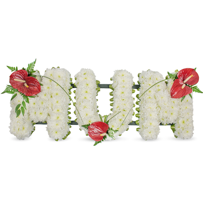 A poignant, carefully constructed memorial piece reads MUM in bold, freestanding capitals fashioned from tight clusters of pristine white spray chrysanthemums. The chrysanthemums' small rounded heads are densely set to produce a smooth, voluminous texture that suggests purity and calm, while a dark green structural base is intentionally left visible at the letter edges to reinforce shape and depth. Three striking red anthuriums - glossy, almost sculptural, each with its distinctive pale yellow-to-white spadix - punctuate the composition: one placed toward the upper left of the first 'M', a second settled at the lower curve of the central 'U', and a third adorning the upper right of the last 'M'. Surrounding each anthurium are sprays of deep green foliage including feathery fern tips and broader tropical leaves; slender, arching blades of grass or stem tie the trio together, sweeping across the white letters and lending a sense of movement. The contrast of the anthuriums' waxy sheen against the chrysanthemums' matte softness creates a refined visual rhythm, held in soft, even daylight that enhances the whites without glare. Designed as a traditional funeral or sympathy tribute, this arrangement communicates enduring love, honor and remembrance for a mother. Locally crafted for families near New Barnet station and the surrounding communities, it balances formal elegance with gentle, consoling sentiment for services, wakes and graveside farewells.