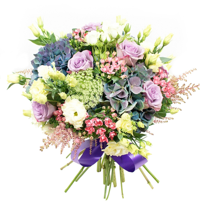 Expertly arranged with the unmistakable touch of a New Barnet florist, this generous bouquet radiates opulence and artistry. The eye is drawn to a wealth of hydrangeas, their large mopheads blending hues of indigo, soft teal, and muted purple for a striking focal point. Interspersed, elegant roses in shades of dusty lilac and creamy white unfurl with classic beauty, accompanied by tightly packed white ranunculus that provide plush, layered contrast. Slender lisianthus stems rise among the blooms, their gentle pale yellow buds and blossoms imparting a breath of spring freshness reminiscent of mornings in the neighbourhood's Hadley Green. The arrangement shimmers with movement thanks to the inclusion of fuchsia-pink accents and soft, wispy pink astilbe plumes at the edges. Intricate light green and white lacy flowers, similar to Ammi Majus, thread through the ensemble, lending delicate texture and botanical interest. Deep green foliage anchors the bouquet and enhances the brilliance of each bloom, while the stems are gathered with precision and finished in a sumptuous royal purple satin ribbon for a final touch of polish. Perfect for birthdays, anniversaries, or heartfelt thank-yous, this bouquet - available for same-day delivery throughout New Barnet - is a lush expression of design, texture, and local charm, ready to become the heart of any celebration.