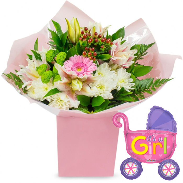 A charming new baby girl floral gift is presented against a bright white backdrop, allowing every colour and curve of the arrangement to be clearly seen and imagined. The focal point is a square, blush-pink gift box, tall and sturdy, filled with an abundant bouquet that appears freshly prepared by a local New Barnet florist. Rising from the box is a rounded, carefully balanced arrangement where a single bright pink gerbera daisy stands confidently at the centre, its broad petals forming a perfect circle and drawing the eye. Around it, pristine white chrysanthemums cluster together, their many-fingered petals creating a soft, cushion-like texture. Light pink and white speckled alstroemeria lilies arc gracefully from the middle, their delicate markings adding an almost painterly touch. A few creamy yellow lily buds emerge from the top, still closed, hinting at blooms yet to open, a gentle echo of the new life being celebrated. Vivid lime-green button flowers, perhaps Santini chrysanthemums, are tucked between the larger blossoms, giving the design a fresh, modern twist, while dark green leaves and airy fern fronds frame the flowers with natural movement. Here and there, polished red hypericum berries peek out, like tiny treasures adding depth to the pastel palette. The entire bouquet is wrapped in folds of soft pink tissue and a layer of clear cellophane that glints in the light, then set snugly inside the pastel box, just as it might be arranged for delivery to homes off East Barnet Road or near New Barnet station. To the right of the florals, a metallic foil balloon shaped like a baby pram floats gently, predominantly hot pink with a purple hood and wheels embellished with colourful spokes. On its side, bold yellow and green letters cheerfully declare It's a Girl!, surrounded by small heart motifs. United, the flowers and balloon form a warm, joyful tableau that perfectly captures the excitement of welcoming a baby girl in the New Barnet area, ideal for baby showers, hospital visits, or proud first days at home.