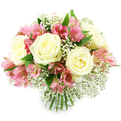 A rounded, hand-tied bouquet of creamy white roses, pink alstroemeria, and delicate white baby's breath rests against a pure white background, its colours and forms clearly defined in bright, even lighting. Several large white roses create the focal points, their petals layered in soft spirals that curl outward from warm, slightly buttery centres, giving the blooms a plush, almost luminous quality. Nestled between these classic roses are generous sprays of pink alstroemeria, also known as Peruvian lilies, their narrow petals arching outward in graceful trumpets. The alstroemeria petals blend shades of soft blush and vibrant fuchsia, with fine darker markings along the inner petals that add texture and a lively contrast to the calm white of the roses. Scattered delicately throughout are many small sprigs of baby's breath, each stem branching into clusters of tiny white florets that seem to float like fine lace or light snowfall between the larger blooms. Glossy deep green leaves frame the composition from beneath, emerging just enough to show the natural structure of the bouquet without overwhelming the flowers. The stems are clearly visible at the bottom, tightly bundled in a professional, hand-tied finish that suggests the care of an experienced New Barnet florist familiar with local celebrations from Hadley Green gatherings to quiet family dinners near New Barnet station. The overall shape is domed and harmonious, giving the impression of fullness without heaviness, and evoking a sense of calm joy and sincerity. This bouquet feels perfectly suited for marking milestones, saying thank you, or simply bringing a touch of refined beauty into a New Barnet home.