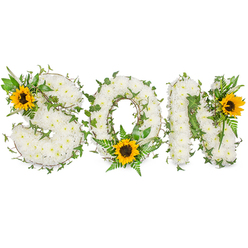 Presented horizontally against a clean white backdrop, this memorial tribute clearly spells SON in solid capital letters, each letter meticulously formed from hundreds of compact white chrysanthemums. The dense floral surface creates a soft, tactile look: the round chrysanthemum heads sit together like snowdrifts of petals, their subtle scent lending a calm, almost restorative presence. Dark green ivy is threaded through all three letters, its sinuous tendrils and glossy leaves providing contrast and a sense of continuity; lighter green fern fronds and pointed leafy stems are layered in to add texture and depth without breaking the letter shapes.

Bright yellow sunflowers act as deliberate focal points - one positioned on the upper-left curve of the S, one cradled at the lower centre of the O among fern fronds, and a third placed at the upper-right of the N. Their broad, golden rays and dark brown, textured centres draw the eye and introduce warmth into an otherwise serene palette. Shot in neutral lighting to preserve colour accuracy, the composition reads with clarity and dignity, suitable for printed order catalogues or online memorial galleries.

I often prepare pieces like this for families around New Barnet, mindful of local places of remembrance from Station Road to Hadley Wood. The combination of white chrysanthemums, evergreen ivy, and cheerful sunflowers conveys respect, enduring love, and a gentle hope - an arrangement crafted to honour a beloved son with quiet beauty and thoughtful horticultural skill.