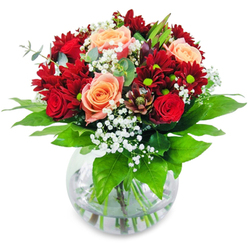 Picture yourself holding this exquisite bouquet-crafted with care for residents of New Barnet, where local spirit meets floral artistry. The bouquet's foundation is a gathering of plush, rich red chrysanthemums and deep ruby roses; each blossom feels like a soft velvet embrace, their passionate shades recalling sunsets on Lyonsdown Road. Nestled among them are tender, peach-infused roses, their gentle radiance softly illuminating the bolder hues and evoking the promise of new beginnings. Scattered clouds of gypsophila drift like snowflakes, lending a breezy lightness reminiscent of walks through Oak Hill Park in early spring. Sturdy green stems and glossy foliage rest in crystalline water, emphasising the bouquet's freshness and reinforcing the connection to nature just outside your New Barnet doorstep. As you inhale, there's a subtle tapestry of sweet rose, fresh greenery, and a whisper of woodland air. Ideal for centrepieces at intimate dinners, milestone birthdays, or cherished celebrations, this arrangement brings a mood of uplifting joy-like a heartfelt congratulations or a gentle encouragement. Every blossom is chosen and placed with intention, ensuring that the final composition radiates both harmony and the personal touch that only a true New Barnet florist can provide.