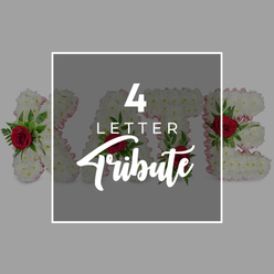 This image presents a refined, peaceful advertisement for a four-letter funeral flower tribute, as you might see when arranging memorial flowers for a New Barnet service. At the heart of the composition is a set of floral letters, likely spelling the name KATE, placed side by side on a neutral light grey ground that feels like the calm interior of a local chapel or funeral home near Station Road. Each letter is meticulously formed from tightly clustered white chrysanthemums, their petals layered so closely that the surface looks like soft snow or fine lace, inviting the fingertips. A narrow edging of pale pink ribbon outlines the shape of each letter, bringing a hint of blush warmth and suggesting gentleness and affection. Scattered through the white flowers are rich red roses, set in small clusters with glossy green foliage, their deep colour standing out like treasured memories against the purity of the white blooms. Over the centre, a dark grey, semi-transparent square panel is placed, bordered with a precise white frame. On this overlay, the words "4 LETTER" appear in strong white capitals above the more fluid script of "Tribute," the numeral "4" slightly oversized and commanding attention. Despite the overlay, the viewer can still see the textured flowers, flashes of red, and green leaves beneath, linking the text clearly to the product. The outer background is a plain, harmonious grey, free from distraction. The photograph conveys not just the design of customised name tributes, but the gentle, personal way families around New Barnet choose to say goodbye through flowers, using simple, elegant letters filled with care.