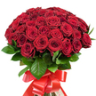 A lavish bouquet of approximately fifty to sixty vibrant red roses commands attention, expertly arranged into a rounded, abundant dome. The petals, richly hued and velvety to the eye, alternate between tightly wound buds and fully blossomed flowers, revealing complex layers and evoking the timeless elegance found in many gardens across New Barnet. Lush, dark green leaves provide striking contrast, their glossy surfaces illuminated by the natural light reminiscent of a summer's afternoon in Oakhill Park. At the bouquet's base, a luxurious wide red satin ribbon, tied into a generously sized bow, completes the visual harmony and underscores the artistry of local florists at Flowers New Barnet. This visually stunning arrangement-ideal for making grand romantic gestures, celebrating anniversaries, or honouring special occasions within the community-radiates a sense of heritage and craftsmanship. The bouquet's palpable freshness and theatrical presence are a reflection of the high standards and heartfelt service characteristic of New Barnet's finest flower experts, ready to bring warmth and joy to any home across the area.