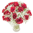 A dreamy, timeless bouquet of velvety deep-red roses cradled in a halo of feathery white baby's breath, arranged with a gentle domed silhouette and set in a simple clear glass vase. Each of the eighteen to twenty roses is shown fully open, their crimson spirals of petals catching the light so the velvety texture reads almost tactile; between them, countless tiny gypsophila blossoms float like a soft mist, the white clusters tempering the intensity of the reds and lending an airy, romantic balance. Through the transparent vase the long, freshly cut green stems and clear water are visible, adding a botanical honesty to the composition and a vertical counterpoint to the rounded head. The photo is bathed in bright, even daylight that highlights both the dewy sheen on the rose petals and the delicate, cloud-like structure of the baby's breath; a faint suggestion of the roses' warm fragrance seems almost present. As a florist familiar with New Barnet and the quieter routes around Oak Hill Park, I picture this arrangement on a mantelpiece in a home off Station Road or placed by a bedside following a small family celebration, where its classic language of love feels perfectly at home. The overall mood is one of considered elegance-romantic without excess, richly coloured yet softly balanced-a bouquet that reads as both a heartfelt declaration and a piece of floral craftsmanship, ready to bring comfort and celebration to everyday moments and special anniversaries alike.