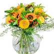 This eye-catching bouquet channels the radiance of New Barnet's brightest summer days into a single, vibrant arrangement. Large sunflowers, with their golden rays and bold brown centers, serve as a lively focal point, surrounded by sunny yellow roses whose petals curl in perfect, classic spirals. The dynamic interplay of glossy red Hypericum berries and lush green foliage gives the bouquet both depth and a festive, playful touch, much like a stroll through the bustling markets near New Barnet railway station. Wisps of feathery ferns spill gracefully from the edges, joined by light green sprigs and airy goldenrod, while bluish eucalyptus leaves peek through, lending notes of coolness and tranquility. The clear, round glass vase reveals the entwined stems shimmering beneath the surface, highlighting the freshness and thoughtful artistry of a locally made bouquet. Sunlight brightens the whole ensemble, casting delicate shadows and infusing the bouquet with an atmosphere of celebration-perfect for marking a milestone birthday, welcoming a loved one, or simply uplifting the heart of a home in New Barnet. Each element, from petal to leaf, is chosen for its quality and meaning, reflecting the pride and expertise of florists who understand the beauty and tradition of their community.