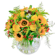 Brimming with the cheer and colour of a sunlit afternoon, this bouquet echoes the vibrancy found across New Barnet's bustling corners and quiet gardens. At the heart, sunflower faces glow with bold, golden petals-each one centering a velvety brown eye full of character and energy. Nestled nearby, yellow roses unfold in creamy spirals, their soft fragrance carrying a message of joy much like a friendly greeting on Station Road. Pops of vivid orange blooms and clusters of red berries punctuate the arrangement, adding playful texture and dynamism, while wispy ferns peek out with a suggestion of motion-like a gentle breeze stirring through Highlands Gardens. Carefully arranged in a rounded glass vase, the stems tangle artfully within, grounding the bouquet in elegance and simplicity. The scent is clean and subtle, threaded with notes of green foliage and newfound happiness. Thoughtfully designed to uplift and inspire, this is a bouquet that embodies the friendly optimism of New Barnet, ideal for birthdays, heartfelt thanks, or simply sharing a ray of local sunshine from Flowers New Barnet.