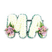 A beautifully structured funeral letter tribute spells out MA in large, clear capitals, carefully arranged so that each detail is visible against a stark white background. The body of both letters is packed tightly with immaculate white chrysanthemums, their many-petalled heads forming a soft, even surface that suggests comfort and serenity. Around the outer edges, a deep emerald green pleated ribbon runs smoothly, its sheen and gentle folds framing the flowers like a tailored edge on a favourite garment, and giving the letters strong definition from every angle. The two letters are set close together, joined subtly so they read as one united word, as you might see them displayed at a New Barnet funeral or memorial gathering. At the lower base of each letter sit two matching accent arrangements that add a whisper of colour and intimacy. Here, full-headed pink and lavender roses open beside smaller pink spray roses, their petals velvety and delicately curled. Fern fronds and small clusters of leafy greenery extend from these posies, introducing soft movement and a touch of natural wildness reminiscent of local New Barnet green spaces and quiet garden corners. The palette of pure white, rich green, and gentle pastel tones gives the tribute a sense of purity, gratitude, and deep affection, making it a fitting choice for honouring a mother, grandmother, or cherished Ma. The overall design suggests the steady hand of an experienced New Barnet florist, balancing precision in the lettering with an emotional, human warmth that speaks of family ties, shared stories, and a respectful final goodbye.