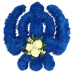 A beautifully composed Sikh Khanda floral tribute dominates the scene, displayed against a spotless white background that emphasises every curve of the sacred symbol. The central sword, round chakkar, and two outward-sweeping kirpans are all meticulously shaped from a dense covering of royal blue chrysanthemums or similar clustered blooms. This close, even coverage creates a sumptuous, velvety appearance, with the rich blue colour conveying dignity, spiritual strength, and a calm, meditative mood. The floral surface appears slightly raised, and faint shadows around the edges give the impression that the Khanda gently floats above the background, much like a carefully placed tribute on a chapel stand in New Barnet. At the base of the main sword, a contrasting posy introduces softness and light. Three creamy white roses, fully formed but not yet overblown, sit at the heart of this cluster, their petals smooth and cool in appearance. They are surrounded by clouds of tiny white filler flowers and framed by polished, dark green leaves that provide structure and freshness. This touch of white and green against the royal blue suggests purity, remembrance, and the hope of peace for the departed. The overall mood is one of stillness and respect, as if the tribute has just been laid by loved ones at a gurdwara or funeral home serving the New Barnet community. You can sense the experienced hands behind it, a local florist who understands both the symbolism of the Khanda and the need to create a comforting, meaningful arrangement for families saying their final goodbyes.