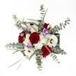 Gazing at this uplighting bouquet is like experiencing New Barnet in bloom-vivid, welcoming, and full of subtle contrasts. At its center, lush red roses unfurl in velvety spirals, exuding passion and sophistication in harmony with the lively energy of the neighborhood. Clusters of pure white gerbera daisies and smaller spray chrysanthemums wrap the roses in a delicate embrace, their petals glowing softly against the background, reminiscent of sunlight dancing on the pavements of East Barnet. Wisps of pale lilac lisianthus weave through, lending gentle elegance and a fresh, tranquil note that uplifts the entire arrangement. Eucalyptus stems fan outward, their silvery leaves evoking moments spent in local parks and gardens, infusing the bouquet with a light, invigorating scent and a contemporary twist. Bright natural lighting illuminates every bloom and leaf, revealing intricate textures and careful placement. Whether gracing a birthday table, brightening a cozy anniversary dinner, or serving as a thoughtful gesture for a loved one in New Barnet, this bouquet reflects genuine care and artistry-the perfect local flourish for moments both big and small.
