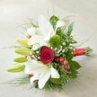 Presented on a softly textured, neutral background, this hand-tied bouquet captures the essence of romantic celebration as envisioned by Flowers New Barnet for their neighbours. Showcasing a harmonious blend of open white lilies with gracefully curled petals and fresh green buds promising tomorrow's blossoms, the arrangement immediately draws the eye. At the heart sits a single, opulent deep red rose, its velvety petals swirling in a mesmerising spiral and suggesting timeless love. Uniquely plush, moss-like green dianthus spheres are nestled amid the blooms, while delicate sprigs of baby's breath appear like airy clouds, lightening the visual composition and adding whispers of innocence to the design. Wispy light green and darker, glossy foliage frame the bouquet, enveloping it with fullness reminiscent of the lush plantings along the streets of New Barnet. Adding a pop of brightness, clusters of vivid red hypericum berries offer youthful cheer and natural detail. Every stem is bound neatly by a crimson satin ribbon, complementing the red rose and uniting the ensemble with a sense of occasion. This thoughtfully arranged bouquet, both traditional and modern, is perfect for New Barnet weddings, anniversaries, or birthdays-exuding the joy, sincerity, and craftsmanship that come from local floristry rooted in the heart of the community.