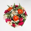 A joyful symphony of colour and texture, this bouquet is crafted locally in New Barnet to celebrate the happiest of occasions. At its vivid core, brilliant orange gerberas radiate vibrant energy, catching the light in a way that makes them almost shimmer-much like the lively markets along High Street on a Saturday morning. Surrounding them, opulent magenta carnations and softly blushing roses create a plush, sumptuous tapestry, with each bloom offering an invitation to touch their velvety softness. Scattered throughout, white alstroemeria and petite daisies are like delicate drops of morning dew, lending a refreshing hint of innocence and purity. The foliage, abundant yet perfectly in proportion, provides a lush, glossy frame-its deep green hues enhancing the palette's honest warmth. The bouquet's arrangement feels thoughtfully harmonious, exuding optimism, handcrafted artistry, and the welcoming spirit of New Barnet. Designed for life's joyful milestones-be it a birthday, heartfelt congratulations, or simply infusing a room with summer's embrace-this floral design delights the senses, blending gentle perfume, tactile richness, and radiant colour into an uplifting display, available for local delivery across New Barnet and neighbouring areas.