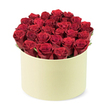 Captured from a slightly elevated, three-quarter angle, this lush red-rose arrangement sits snugly inside a round pale cream box. The bouquet contains about twenty-four crimson roses, their petals tightly furled and velvety, announcing that each bloom is at its prime. They are arranged to completely fill the cylindrical box, forming a dense dome that rises a touch above the rim, a testament to careful, precise artistry. A touch of green foliage threads through the blossoms, giving natural contrast and a sense of garden freshness against the deep red. The box itself has a smooth matte finish in soft ivory, echoing the vintage charm of a classic hat box while maintaining contemporary chic. The white background isolates the arrangement, letting the colors, textures, and craft speak clearly.
This arrangement is an ideal gift for romance, anniversaries, or Valentine's Day, and in New Barnet it would be a staple for same-day delivery to EN5 and the surrounding wards. The fragrance of roses would fill the room as the blooms open and settle, the petals velvety to the touch, the edges satin-smooth. The composition bears the signature of a practiced florist-balanced, dense, and lush-inviting a moment of quiet admiration. The overall mood is one of love's quiet celebration: premium, intimate, and luxe, perfect for a thoughtful friend or partner who deserves a gesture with real style.