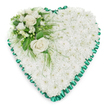 A classic heart-shaped funeral arrangement, carefully crafted from a solid bed of white chrysanthemums that cover the entire heart in a soft, cushion-like layer of petals. Each small bloom contributes to a sense of purity and calm, their overlapping heads giving the impression of a gentle, snowy blanket. Around the edge, a vivid emerald green satin ribbon has been delicately pleated into rippling folds, framing the heart with a decorative, scalloped border that adds polish and definition. In the upper left section, an accent spray introduces a focal point of interest and tenderness: two full white roses, their petals gracefully unfurled, sit among smaller white flowers such as freesias or similar delicate stems, some still in bud. Deep green foliage, both broad and glossy and fine and feathery, encircles the blooms, draping naturally over the white base to create depth and a soft sense of movement. Set against a bright, neutral white background, the floral heart stands out clearly, allowing the contrast between the pristine white flowers and the rich green detailing to be fully appreciated. This is the sort of tribute a family in New Barnet might select for a funeral or memorial, whether the service is in a nearby church, crematorium, or resting place reached from the High Barnet or Cockfosters direction. The arrangement conveys quiet respect, heartfelt sympathy, and enduring affection, offering a gentle visual comfort to those gathered to say their goodbyes.
