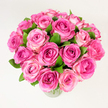 A stunning, lush bouquet of roughly two dozen freshly cut pink roses gathered into a generous, rounded dome and set in a clear glass vase against a clean, evenly lit white backdrop. Each rose is fully or nearly fully open, the petals arranged in tight, velvety spirals that soften toward the edges; the colour travels from a concentrated, jewel-like fuchsia at the heart of some blooms through warmer pinks to pale, almost creamy blush tones on the outer ruffles. Dark, glossy green leaves are tucked between the heads, their cool tone and slight sheen giving the composition natural contrast and visual rhythm. Photographed from a slightly elevated, overhead angle, the arrangement reads as abundant and inviting, the tightly packed flowers forming a soft, rounded silhouette that feels both elegant and comforting. The light is soft and diffuse, catching the satiny texture of the petals and suggesting a faint, powdery rose scent that lingers in the memory. As a local florist describing this piece, I imagine it brightening a mantel on Station Road or arriving as a heartfelt gift for a celebration in Brunswick Park; its palette and form suit anniversaries, Mother's Day, or simply as a gesture of affection. The visual impression is one of joyful romance and considered craftsmanship: carefully selected stems, balanced colour gradation, and an emphasis on freshness. For someone unable to see the photo, picture the warmth of deep pink centres surrounded by softer blush faces, set off by cool green foliage and the transparent simplicity of glass, all presented with the calm confidence of a neighbourhood florist in New Barnet.