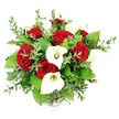 A dramatic bouquet of classic red roses and white calla lilies is presented in a clear glass vase, photographed straight on against a clean white background, giving the arrangement a gallery-like clarity. The roses, a deep, velvety crimson, are tightly packed in full, rounded blooms that create a rich, romantic heart to the design, their layered petals curling inwards like folded satin. Rising above and between them, the calla lilies add height and graceful movement; each lily forms a sleek, trumpet-shaped bloom, its pure white spathe gently wrapping around a slender yellow spadix, lending the bouquet an air of modern elegance and quiet sophistication. Threaded throughout are sprigs of eucalyptus, their fine stems and numerous small, rounded, silvery-green leaves adding texture, lightness, and a hint of cool, herbal freshness, as though the bouquet had been gathered on a calm morning stroll near New Barnet's quiet residential streets. Broader, glossy green leaves nestle behind and between the main flowers, deepening the overall colour palette and emphasizing the abundant, domed shape of the arrangement. Only the ribbed base of the vase peeks out at the bottom edge of the image, its transparency keeping the focus firmly on the interplay of red, white, and green above. The bright, even lighting eliminates distractions and makes every petal and leaf appear crisp and freshly arranged, ideal for a romantic delivery to a New Barnet home, an anniversary surprise near New Barnet station, or a sophisticated centrepiece for a local celebration. The overall impression is one of polished romance and confident, timeless beauty.