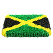 In this image, the Jamaican flag has been transformed into a plush floral tribute, meticulously arranged to convey both national pride and deep respect, as you might see at a memorial gathering in New Barnet or a service held along East Barnet Road. The piece is a solid, rectangular panel with crisp, straight edges, standing out clearly against a plain white background that emphasises its strong colours and craftsmanship. A bright golden-yellow X runs diagonally from corner to corner, its shape formed from a dense band of small, soft-petalled flowers carefully overlapped so no gaps show through. The petals create a gently undulating surface that catches the light, adding a subtle shimmer and sense of movement. Nestled between the arms of this cross, the top and bottom triangles are filled with rich green blooms, their tiny petals or florets ruffled and slightly tousled, reminiscent of fresh grass in Oakleigh Park after a light shower. On the left and right, the triangles are a deep black, crafted from closely packed flowers or petal-like elements with a velvety texture that absorbs light and brings a calm, dignified weight to the design. The arrangement is symmetrical and precise, with every line true, mirroring the iconic Jamaican flag while giving it a tactile, three-dimensional presence. Though you cannot smell it in the image, you can almost imagine the faint, earthy fragrance of fresh stems and foliage. This floral flag feels perfectly suited for funerals, remembrance services, or culturally significant occasions in New Barnet, offering a heartfelt way to honour Jamaican heritage and celebrate a life with beauty and meaning.