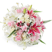 A rich, rounded bouquet of lilies and roses is presented on a clean white background, resembling a freshly finished arrangement waiting for delivery from a New Barnet flower shop. Large white lilies open generously across the top, their smooth petals arching outward to reveal pale yellow and green centres, while a few tight buds keep the composition looking dynamic and newly made. Intertwined with these are clusters of blush pink and creamy white roses, some with tight, cupped forms and others fully expanded, their many layers of velvety petals giving the impression of softness and depth. Bold accents come from vivid fuchsia and magenta Oriental lilies, likely Stargazers, whose vibrant, speckled petals and bright golden stamens add drama and colour balance, much like a bright splash of flowers against the greenery in nearby Oakhill Park. Delicate sprays of white gypsophila weave through the arrangement, creating a fine, cloud-like texture that softens the more structured shapes of the lilies and roses and helps form a perfectly domed silhouette. Hints of slender, glossy green leaves peek from within the dense mass of blooms, suggesting freshly cut stems arranged by an experienced local florist. The bright, even lighting highlights every curve and fold, emphasizing the bouquet's lush fullness and pristine condition. It feels like a design chosen to celebrate life's joyful occasions in New Barnet-perhaps a wedding gift delivered near the station, a romantic surprise on a quiet residential street, or a congratulatory bouquet that brings the fragrance and romance of a classic flower garden straight into someone's living room.
