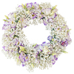 A beautifully composed circular wreath is shown in isolation against a bright white background, its entire surface richly covered in soft white and purple flowers that seem to float like a gentle halo. The foundation of the wreath is made from dense sprays of Baby's Breath, each stem branching into tiny, pristine white flowers that cluster together and create an airy, cloud-like base. This Gypsophila forms a continuous, feathery ring, giving the design a light, almost weightless feel despite its fullness. Sitting delicately on this snowy cushion are graceful Lisianthus blooms, carefully spaced so each one can be appreciated. Their petals are gently ruffled, starting out as pure white and then fading into lilac, lavender, and deeper purple along the fringed edges. The colour changes are soft and organic, like brushstrokes of watercolour, with some blooms showing stronger purple highlights that add depth and subtle drama. A few flowers are still in bud, their pale green casings and hints of cream and lilac suggesting blossoms yet to open, adding a sense of life and continuity to the arrangement. The centre of the wreath is a clear, empty circle, accentuating the traditional symbolic form of eternity and unbroken love often chosen for funeral or memorial tributes in New Barnet and the surrounding area. With no greenery or decorative accessories, the focus rests entirely on the interplay of white and purple, the fine textures, and the quiet craftsmanship typical of local florists who prepare thoughtful sympathy arrangements for services at churches and crematoria around Barnet, offering a gentle visual expression of remembrance and peace.