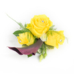 A luminous corsage composed of three buttery yellow roses takes centre stage in this image, each bloom carefully wired and finished with a tiny clear faceted jewel nestling at its heart so the centres catch and scatter light like a soft, private constellation. The largest, fully opened rose forms a warm, sunny focal point, flanked by two slightly smaller roses that are mid unfurl-petals curling with the velvet softness that invites a tender touch. Below this golden trio, a single sculptural calla lily in a deep plum-burgundy arcs gracefully downward and left, its satiny throat and sculpted silhouette creating a dramatic foil to the cheerful yellow. The composition is given breath by wisps of feathery asparagus fern and broader, glossy dark green leaves that ground the piece with cool texture. Small, button-like ivory chrysanthemums sit like polite punctuation among the roses, while a couple of tight green buds peek from the lower right, promising growth and movement. Behind the left rose a whisper of sheer white lace or feathery tulle adds an ethereal halo, a subtle bridal or prom-ready flourish. The scent suggested is gentle and rosy, brightened by green, leafy notes; the overall impression is confident, joyful, and elegant-ideal for a wedding, graduation, or summer ball. Photographed against clean white light that highlights every curve and jewel sparkle, this accessory reads as both refined and celebratory, the kind of piece a local wearer might choose for an occasion in New Barnet near the station or a summer gathering at Victoria Recreation Ground.