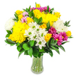 A vibrant, rounded bouquet is showcased in a clear glass vase, set cleanly against a pure white background that lets its colours sing. The eye is first drawn to the bright yellow roses and large yellow chrysanthemums, their densely layered and ruffled petals creating a luxurious, almost cushiony texture at the heart of the design. Scattered between these glowing yellow blooms are clusters of white daisy-like flowers with lime-green centres and soft, fluffy white chrysanthemums, which bring a refreshing, airy balance to the warmth of the yellows. Vivid magenta and fuchsia chrysanthemums add energetic pops of colour, while delicate pastel pink blossoms are tucked more discreetly amongst the larger heads, giving the bouquet a sense of depth and thoughtful layering. Rich, deep green foliage, probably Ruscus with its firm, glossy oval leaves, forms a solid, rounded foundation and threads through the arrangement, enhancing the brightness of the petals and completing the full, domed shape. Through the gently curved sides of the vase, the stems are clearly visible, standing in clear water like a neat bundle just trimmed and arranged in a New Barnet flower shop. The stark white backdrop has a modern, editorial feel that makes this bouquet look especially fresh and contemporary, without losing its warmth. The overall atmosphere is cheerful, generous, and uplifting, the sort of arrangement you might send to a friend near New Barnet station to celebrate good news, to say happy birthday, or simply to brighten a kitchen table on a grey day with a burst of colour and hope.