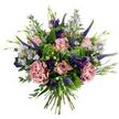 This hand-tied bouquet reads like a breezy English meadow gathered at dawn: soft antique-pink roses, some tightly furled and others gently unfurling to reveal slightly darker pink petal edges, form the peaceful centre. Nearby, two full, dusty-rose carnations lend a plush, ruffled weight, their mauve-pink tones deepening the bouquet's romantic mood. Vertical spires of deep indigo-veronica rise through the composition, their slim, architectural lines giving height and dramatic contrast against the rounded blooms. Sprays of pale lavender-blue, aster-like flowers with tiny yellow centres scatter through the vase, their starry faces providing a light, airy counterpoint. Deeper jewel notes come from small purple lisianthus-buds and open heads that punctuate the pastel palette. The arrangement is cushioned by varied greenery: rounded, silvery-green eucalyptus leaves that soften the colour scheme and bright lime-green, textural filler reminiscent of Santini chrysanthemums that add fresh, verdant energy. Slender green leaves and little emerging buds tuck into nooks between flowers, reinforcing the bouquet's gathered-from-the-garden character. The stems are visible and gathered at the base in a classic hand-tied style, suggesting both care in construction and ease of placement in a simple vase. Soft morning light lifts the pastel shades and brings out a faint, fresh scent of green leaves and floral sweetness, creating an uplifting yet gentle presence for a bedside table or mantel. Ideal for birthdays, thank-you gestures, or simply to brighten a favourite room, this bouquet carries the calm, natural charm of New Barnet's parks and hedgerows, evoking afternoon strolls near Monken Hadley Common.