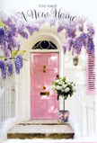 This New Barnet doorstep scene feels like the first page of a cherished new chapter. A pale pink front door stands as the welcoming focal point, its softly brushed finish glowing against whitewashed walls and a faintly textured shutter painted in harmonising blush tones. Overhead, lush wisteria trails down in tumbling streams of lavender and lilac, each blossom suspended in clusters that create a natural canopy, much like the flowering arches you might glimpse in hidden corners off Barnet High Street or near Hadley Green. The petals cast gentle, shifting shadows that play over the doorway, capturing that peaceful moment of late afternoon when the light mellows and colours deepen. At the foot of the door, lovingly placed on the step, is a chic grey metal bucket used as a vase, filled to overflowing with white and creamy roses. Their petals are full and plush, curving outward in soft spirals, while accents of fresh green foliage weave through the arrangement, adding contrast and a sense of just-picked vitality. A delicate pink ribbon encircles the bucket, tied neatly into a bow that echoes the door's pastel charm and provides a tender finishing touch. You can almost imagine the subtle blend of fragrances from the roses and wisteria mingling in the air, offering calm after the bustle of moving boxes and keys changing hands. The image conveys warmth, optimism, and the comforting sense that this floral gift is there to mark a housewarming in New Barnet, bringing beauty, luck, and an immediate feeling of belonging to the new home.
